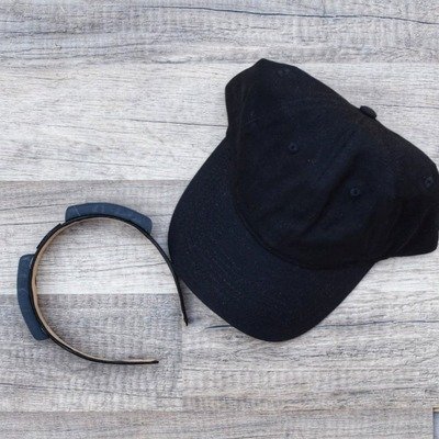Black cap and blue headband on a wooden surface