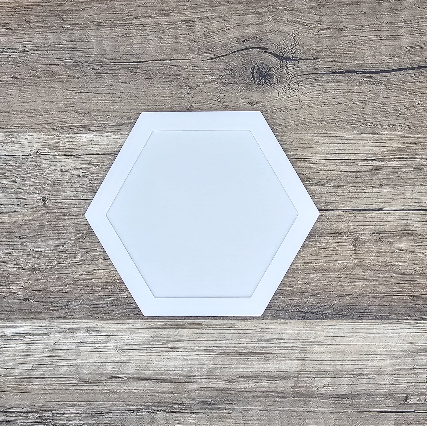 white hexagon shaped picture frame top for a running medal display