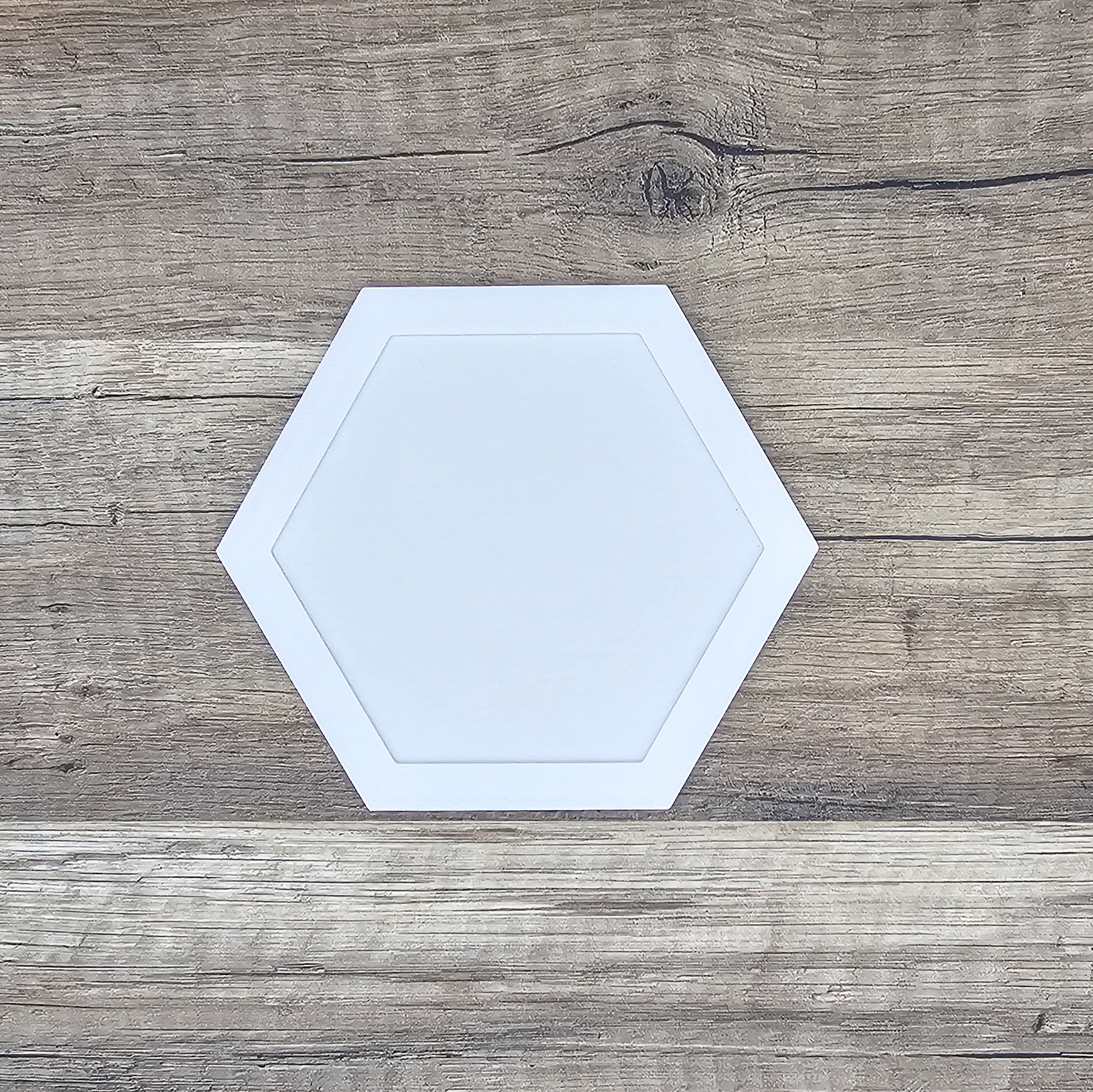 white hexagon shaped picture frame top for a running medal display